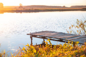 Wooden Pier On The River. Autumn, Sunset