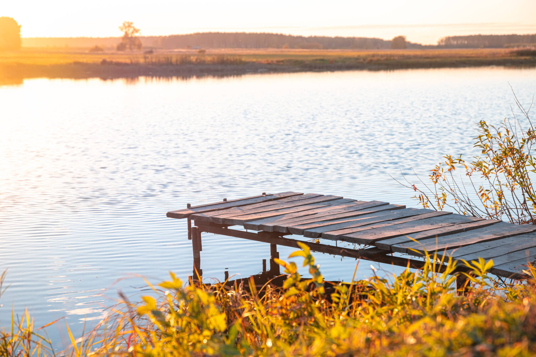 Wooden Pier On The River. Autumn, Sunset